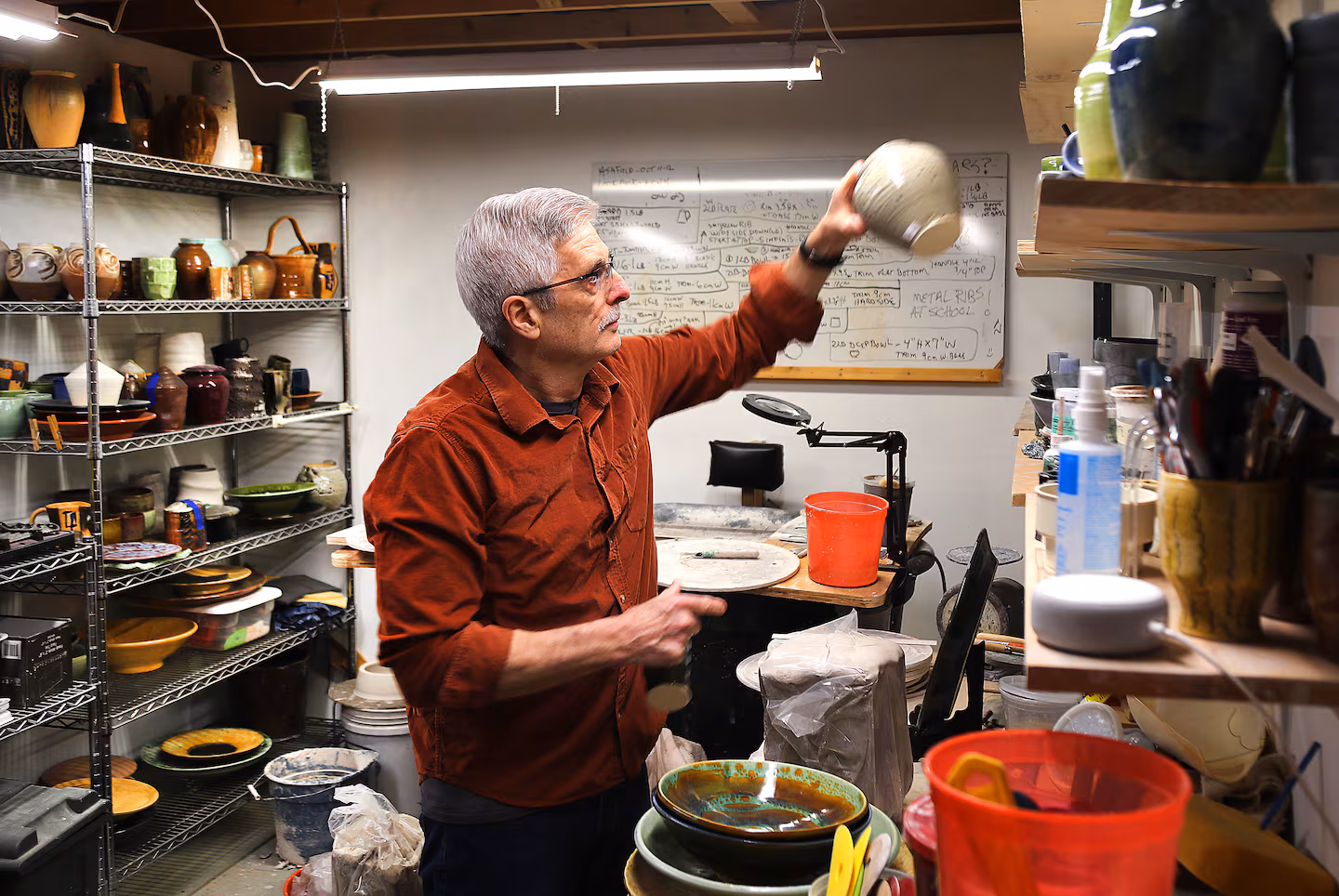 Warren Smith, art teacher at Hampshire Regional High School, works on pottery in the basement studio at the school. Smith is concerned about rising health insurance costs.JOHN TLUMACKI/GLOBE STAFF